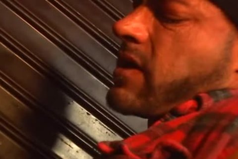 gay pounding in front of the road signs